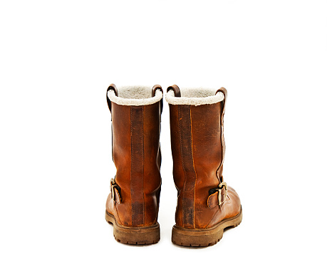 Pair of brown winter boots from the back. Isolated on white background