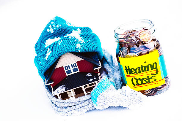 Saving for Winter Heating Costs Saving for WInter Heating Costs winterizing stock pictures, royalty-free photos & images