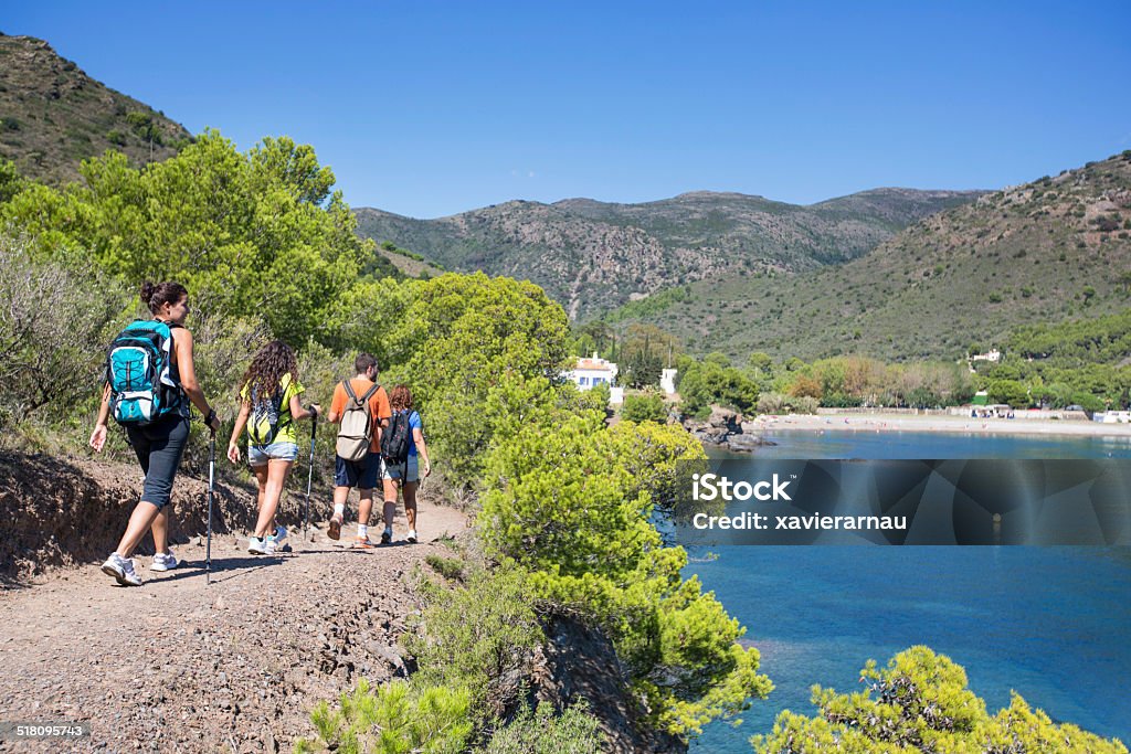 Friends hiking in the mediterranean coast Young people hiking in the mediterranean coast . Hiking Stock Photo