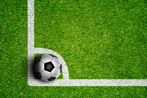 Soccer Ball on Green Grass Field at the stadium