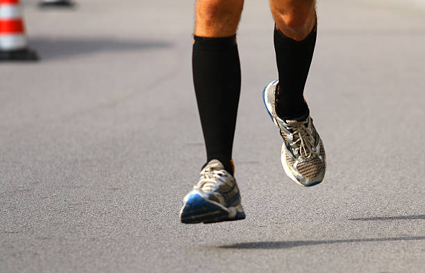 istock very fast runner with sneakers during the Marathon on road 518096273