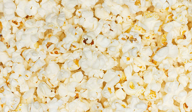 istock Salted popcorn grains on the white background 518096565
