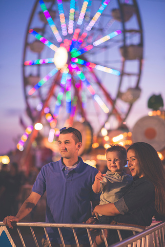 Parents with a young child at a country fair. Shot in Midland, MI.