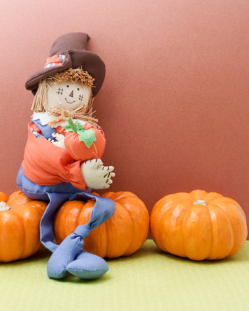 istock Happy Scarecrow Hugging A Pumpkin 518097395