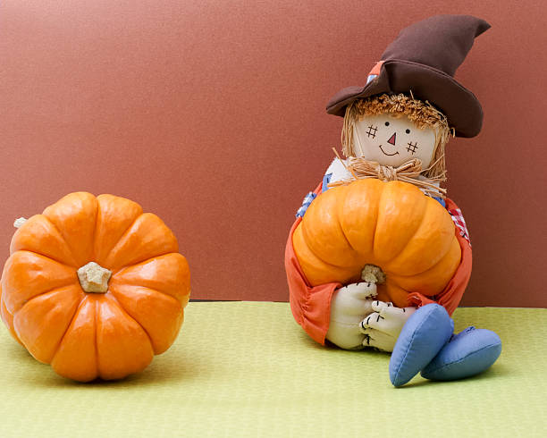 istock Scarecrow Rag Doll Holding A Pumpkin 518097405