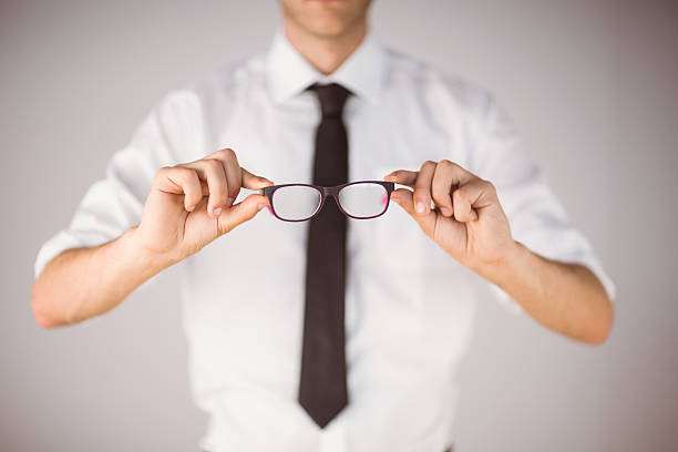 istock Businessman holding his reading glasses 518098215