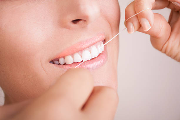 istock Beautiful Smile With Dental Floss 518098871