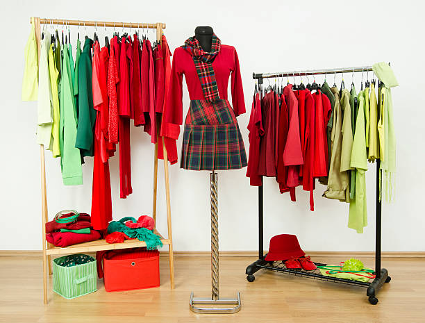 istock Wardrobe with complementary colors red and green clothes on hangers. 518100063
