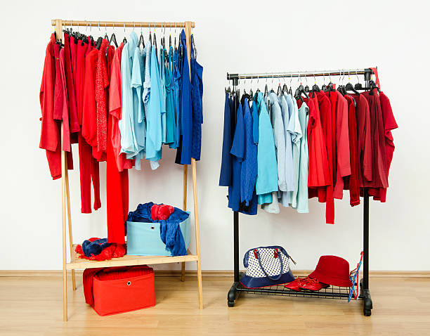 istock Wardrobe with red and blue clothes on hangers. 518100067
