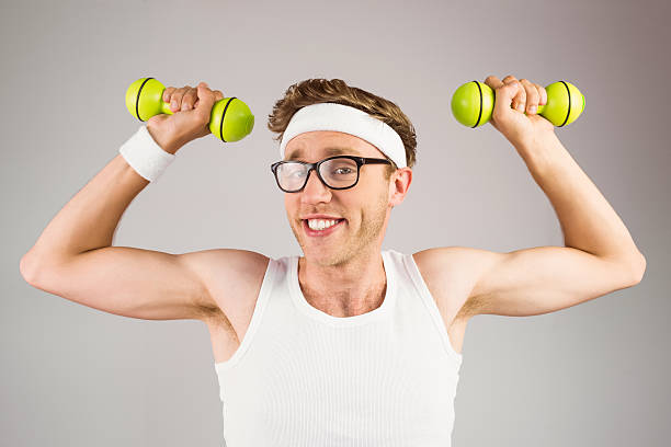 istock Geeky hipster posing in sportswear with dumbbells 518100511