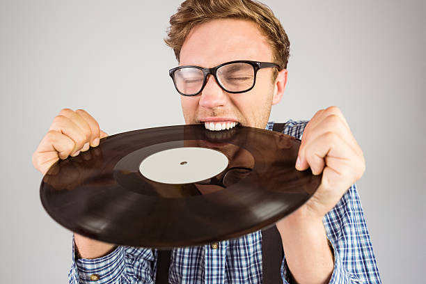 istock Geeky hipster biting vinyl record 518101177