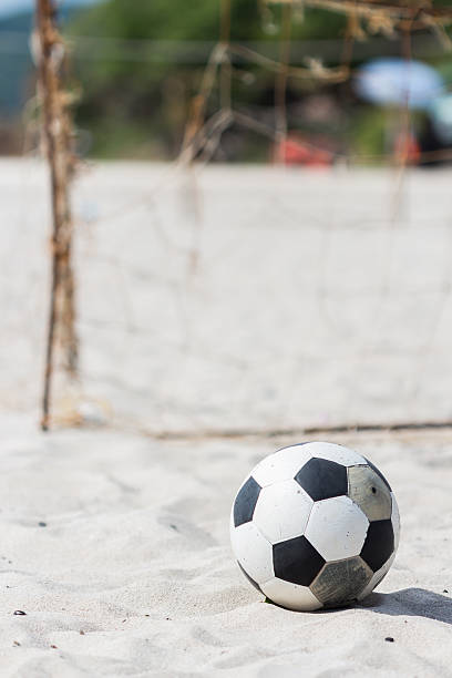 istock football on the beach, holiday 518101257