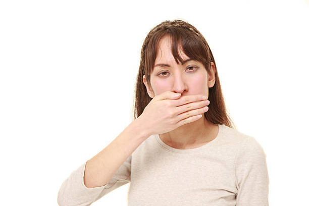 istock woman making the speak no evil gesture 518109388