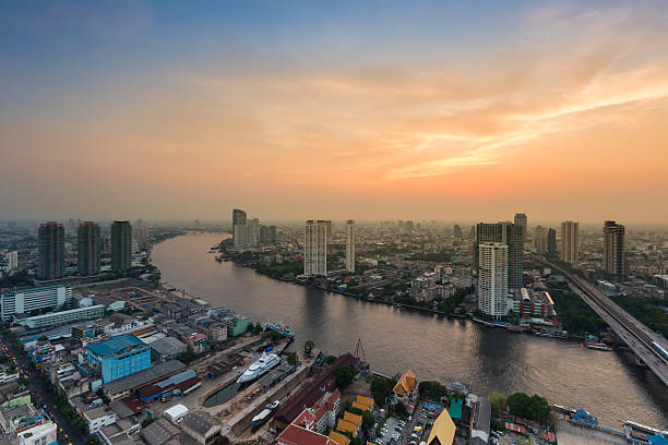 istock City downtown and main river curved with dramatic sky 518110062
