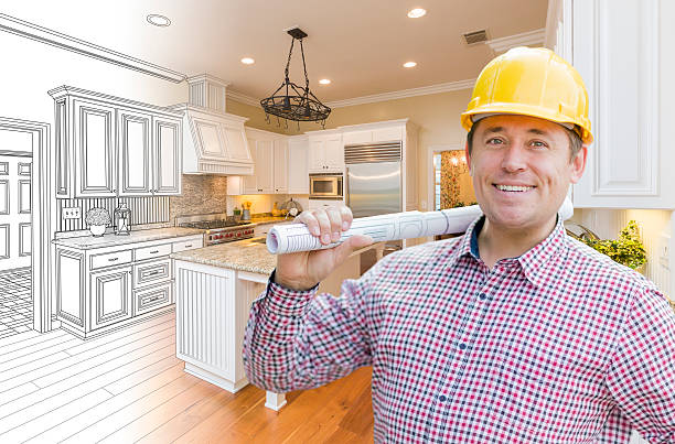istock Contractor in Hard Hat Over Custom Kitchen Drawing and Photo 518110662