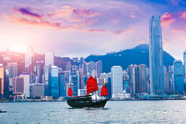 Hong Kong Victoria Harbour Sailboat travel to Hong Kong Victoria Harbour at sunset hong kong business district stock pictures, royalty-free photos & images