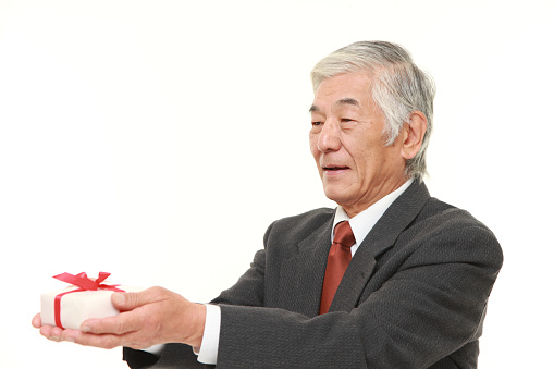 studio shot of senior Japanese businessman on white background