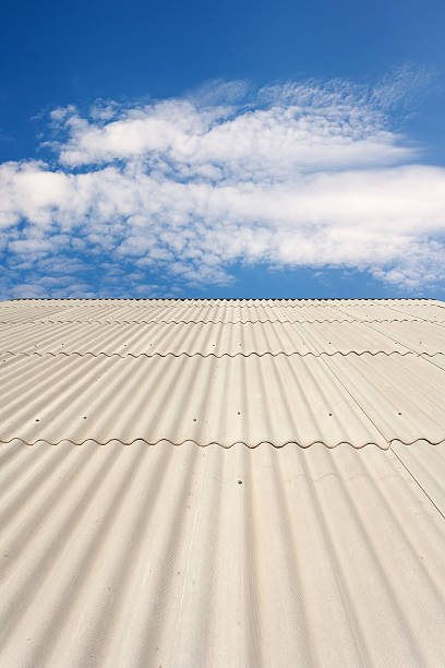 istock Asbestos slate roof against blue sky 518114854
