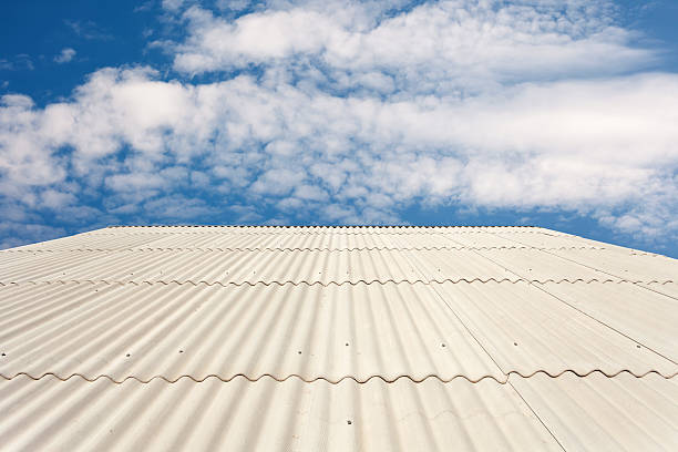 istock Asbestos slate roof against blue sky 518114876