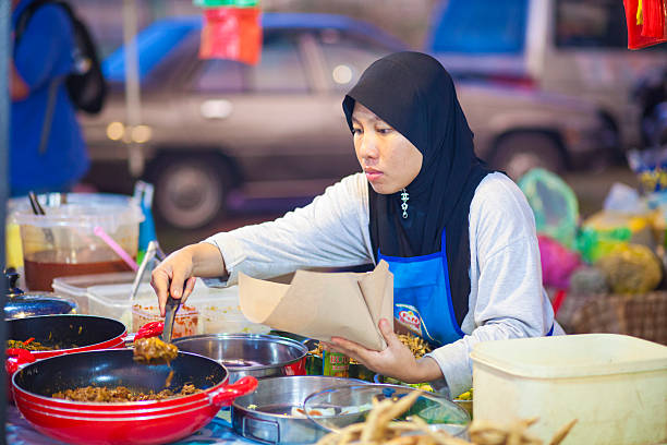 Langkawi, Malaysia - March 10, 2011: A woman prepares food for her stall in Langkawi, Malaysia.