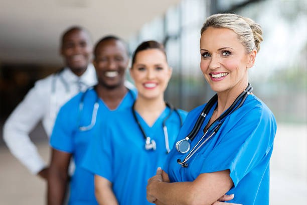 istock female doctor standing in a row with team 518118366