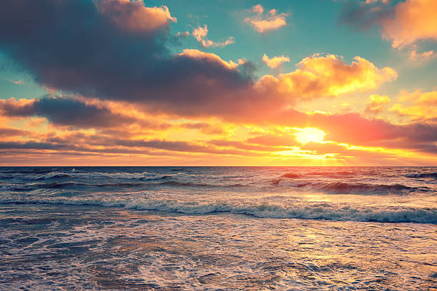istock Sea shore at sunset with cloudy sky 518119182