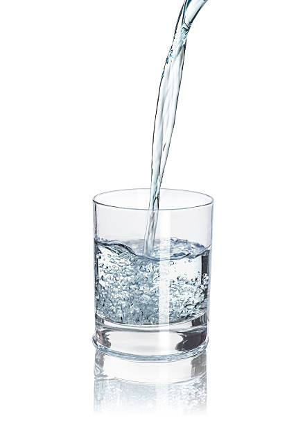 istock pour water into the half-full glass 518121002