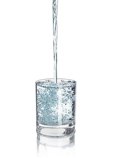 istock pouring water into the glass to the upside 518121692