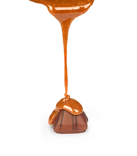 istock Caramel pouring on chocolate candies 518121752