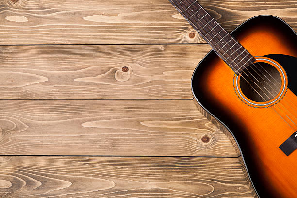 istock Acoustic guitar on wooden background 518137368