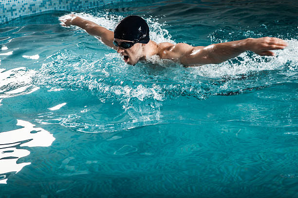 istock Muscular young man swims the butterfly 518137466