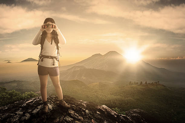 istock Female hiker with binoculars at mountain 518140712