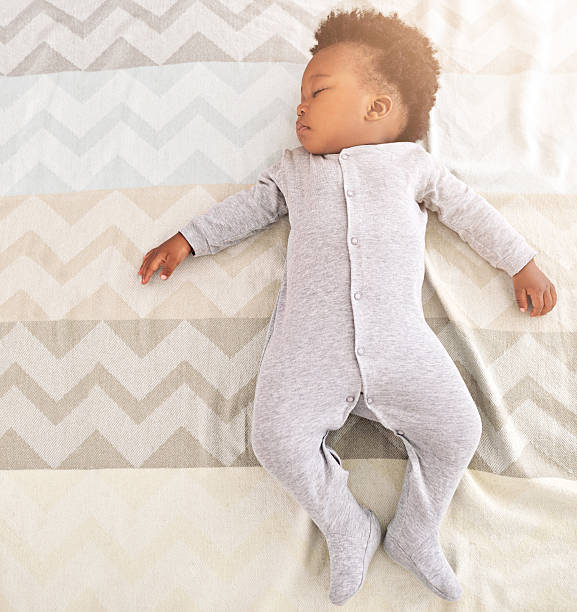 Growing babies need plenty of sleep High angle shot of a little baby boy sleeping on a bed crib photos stock pictures, royalty-free photos & images