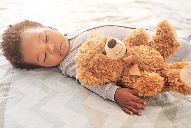 istock With teddy close by he has the softest sweetest dreams 518141630
