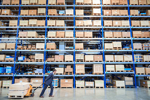 istock Manager carrying cardboard box in warehouse. 518143554