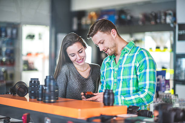 istock Couple in the store looking at digital camera 518143866