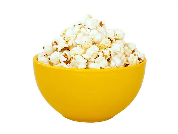 Popcorn in yellow ceramic bowl isolated on white
