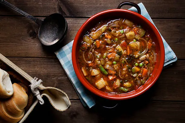 Traditional Italian cuisine minestrone soup prepared on the pot 