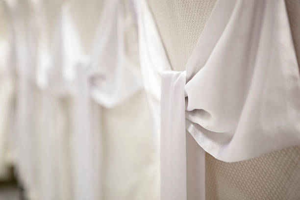 istock wedding decorations - white satin bows on the chair covers 518146494