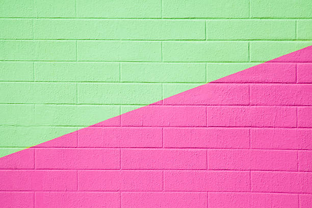 istock Brick wall painted pink and green, background full frame. 518146630