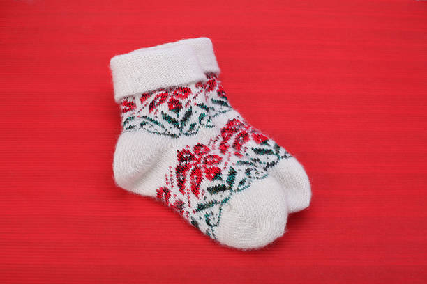 istock Winter knitted woolen socks on red 518148075