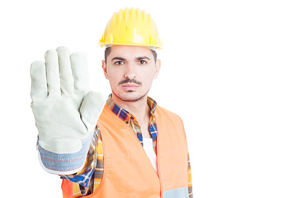 istock Close-up conctructor hand with glove making stop sign 518148114