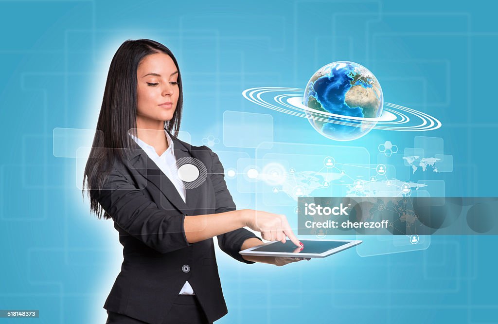 Women using digital tablet and Earth with world map Beautiful businesswomen in suit using digital tablet. Earth with world map and network. Element of this image furnished by NASA Adult Stock Photo