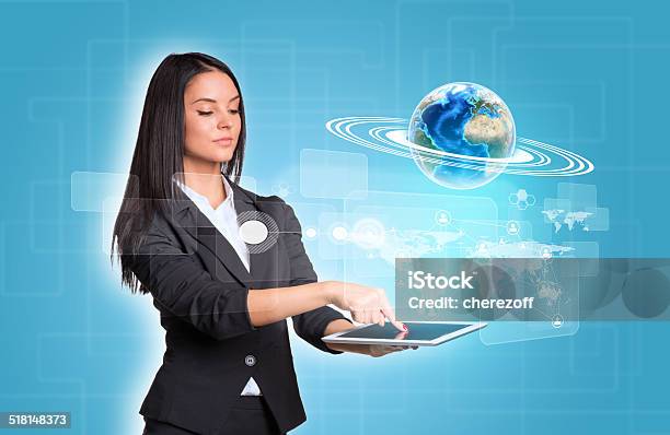Women Using Digital Tablet And Earth With World Map Stock Photo - Download Image Now