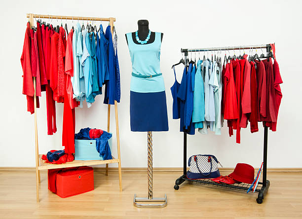 istock Wardrobe with red and blue clothes arranged on hangers. 518148613