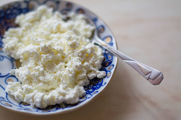 fresh cottage cheese on old wooden table fresh cottage cheese on old wooden table curd cheese photos stock pictures, royalty-free photos & images