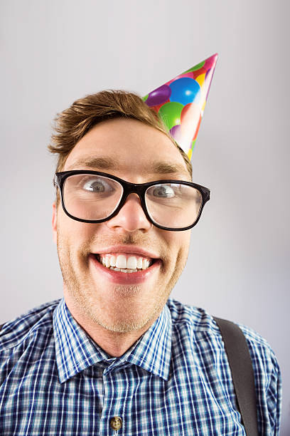 istock Geeky hipster wearing party hat 518149253