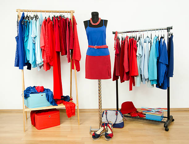 istock Wardrobe with red and blue clothes arranged on hangers. 518150085