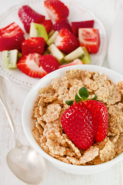 istock cereals with strawberry in white bowl 518150147