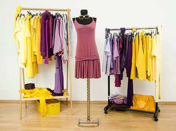 istock Dressing closet with complementary colors violet and yellow clothes. 518150831